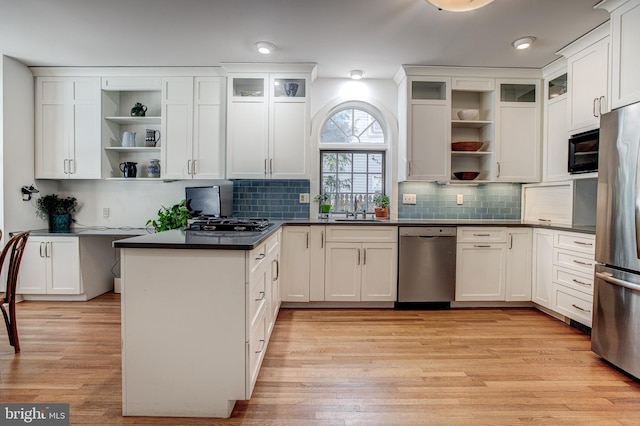 kitchen featuring sink, stainless steel appliances, light hardwood / wood-style floors, and white cabinets