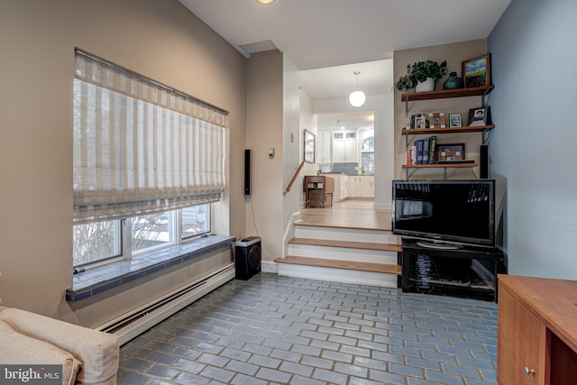 interior space featuring plenty of natural light and a baseboard heating unit