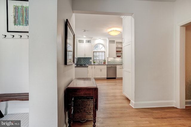 hallway featuring sink and light hardwood / wood-style floors