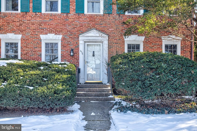 view of snow covered property entrance