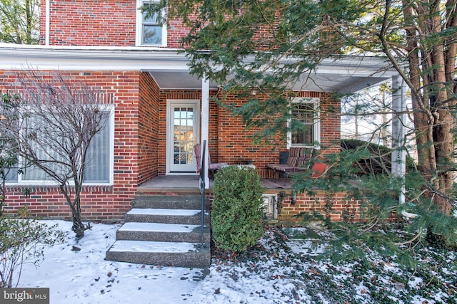 view of snow covered property entrance