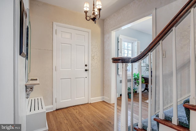 entryway with a notable chandelier and light hardwood / wood-style floors