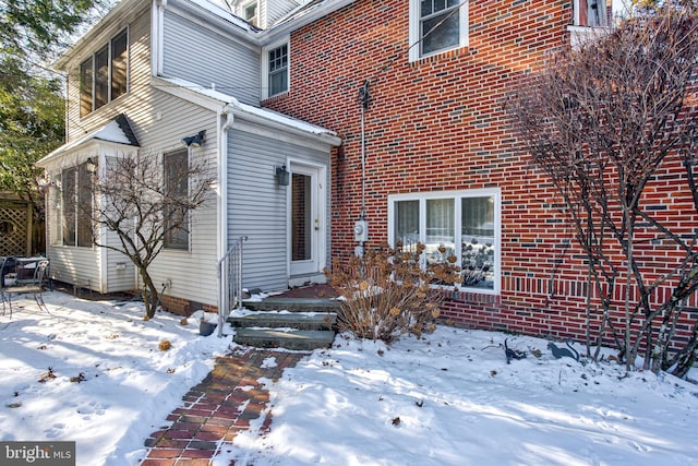 view of snow covered property entrance