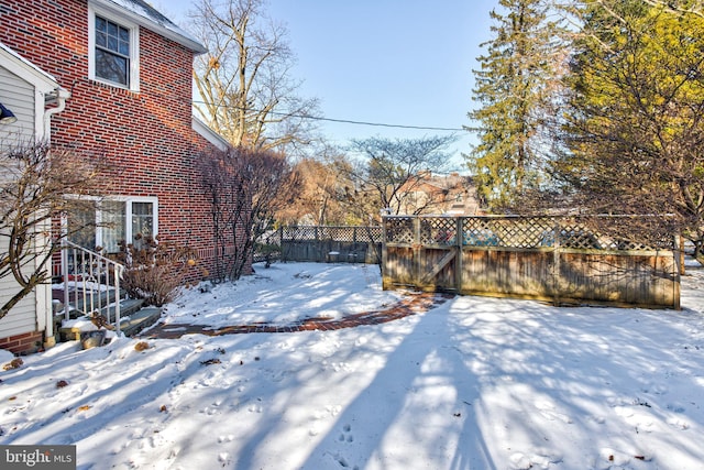 view of yard layered in snow