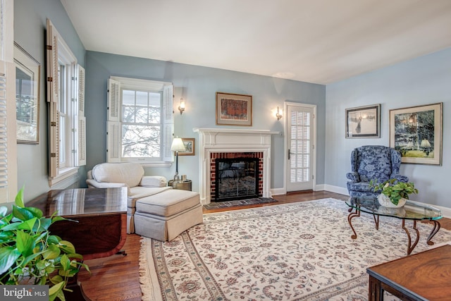 living room with wood-type flooring and a fireplace