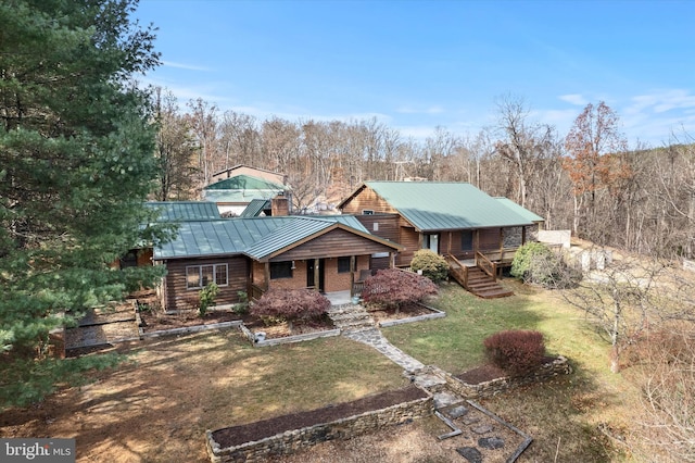 log cabin featuring covered porch and a front yard