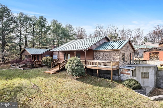 rear view of property featuring a yard