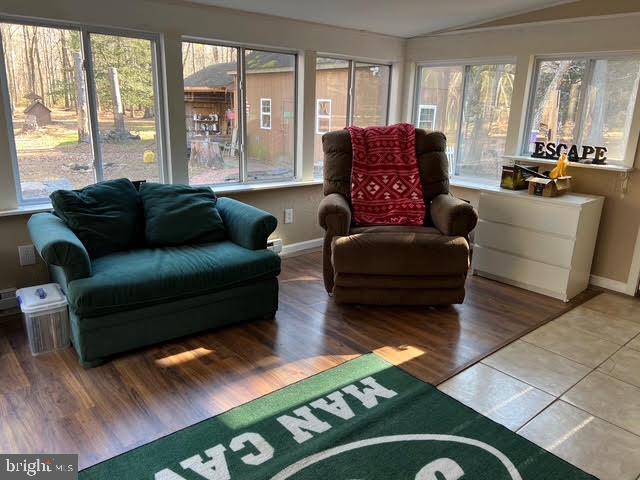 sunroom featuring plenty of natural light and lofted ceiling