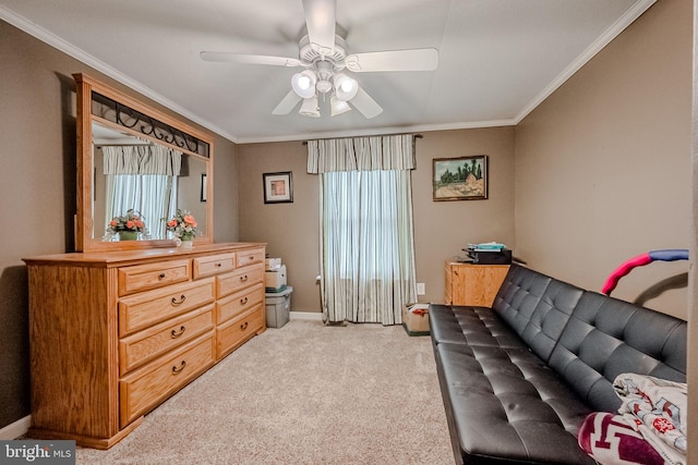 sitting room featuring ceiling fan, crown molding, and light carpet