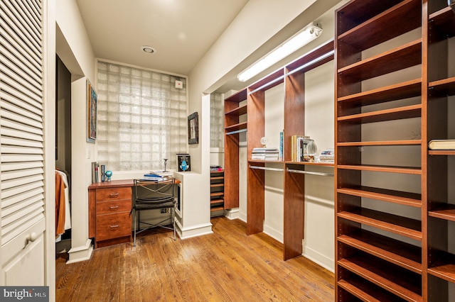 office area featuring built in desk and light hardwood / wood-style floors