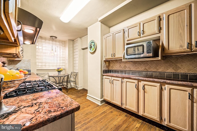 kitchen featuring appliances with stainless steel finishes, tasteful backsplash, and wood-type flooring