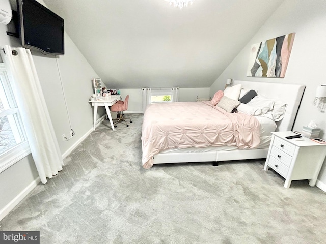 bedroom featuring light colored carpet and lofted ceiling