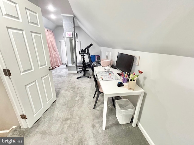 carpeted office with lofted ceiling