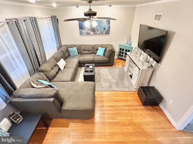 living room featuring ceiling fan, light hardwood / wood-style floors, and ornamental molding