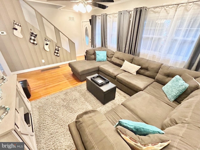 living room featuring ceiling fan and hardwood / wood-style flooring