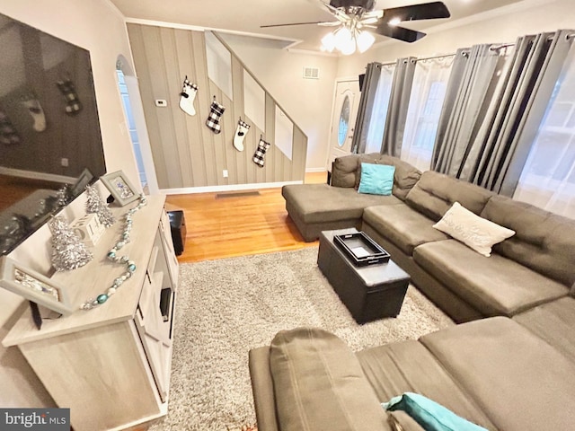 living room featuring ceiling fan and wood-type flooring