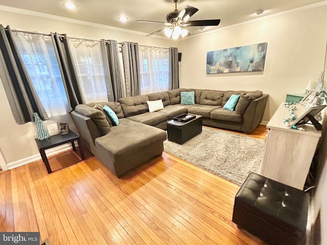 living room featuring light wood-type flooring, ceiling fan, and ornamental molding