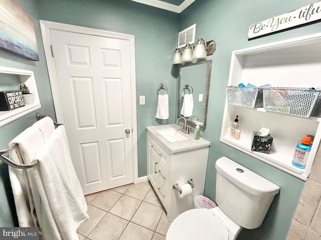 bathroom featuring tile patterned floors, vanity, toilet, and crown molding