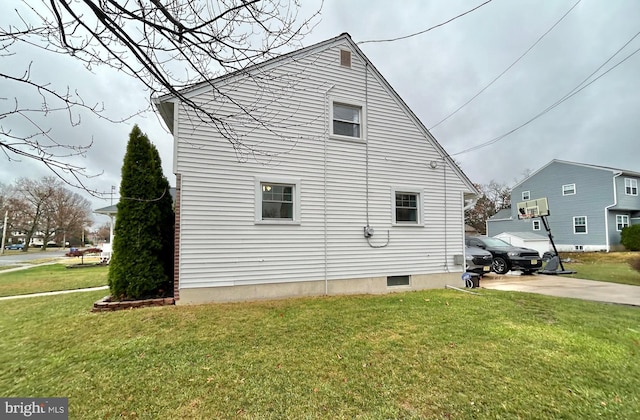 view of property exterior with a yard