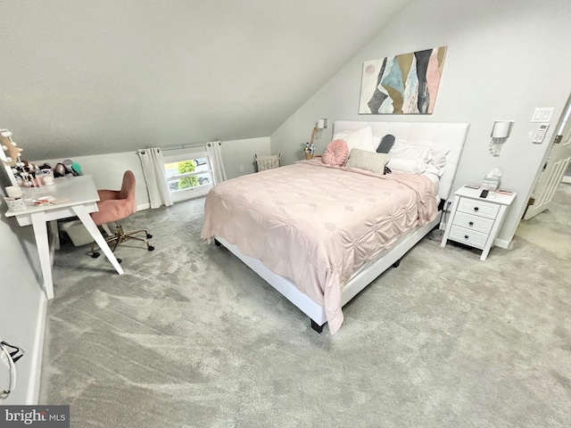 bedroom featuring light colored carpet and lofted ceiling