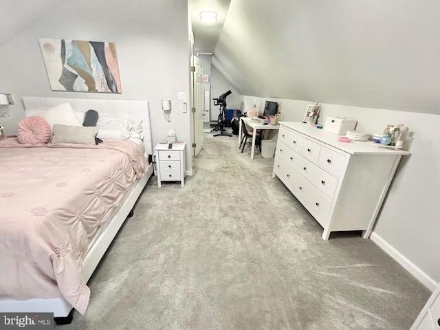 bedroom featuring light carpet and lofted ceiling