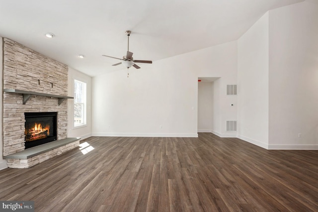 unfurnished living room featuring ceiling fan, a fireplace, and dark hardwood / wood-style floors