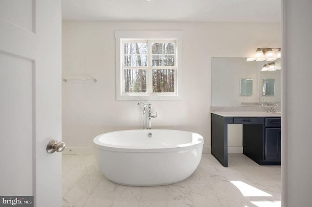 bathroom featuring a washtub and vanity