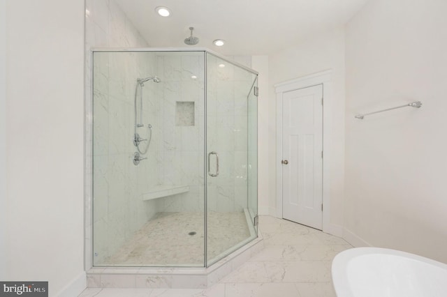 bathroom featuring a shower with shower door