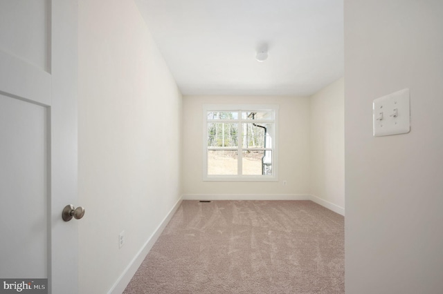 empty room featuring light colored carpet