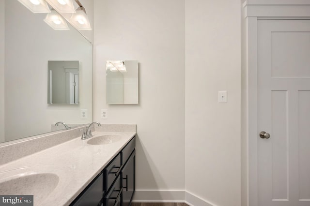 bathroom with hardwood / wood-style floors and vanity