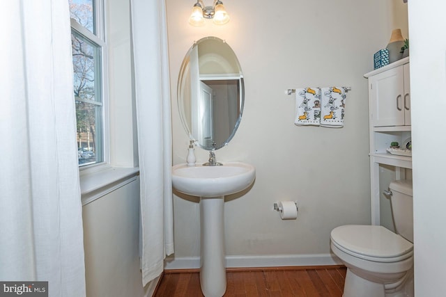 bathroom with hardwood / wood-style floors and toilet