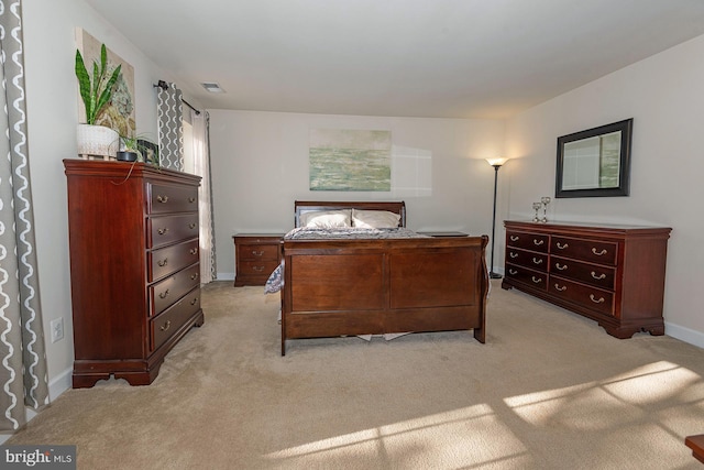 bedroom featuring light carpet