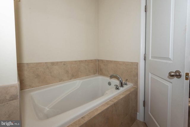 bathroom with a relaxing tiled tub