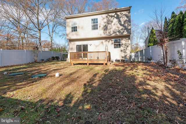 back of house with a yard and a deck