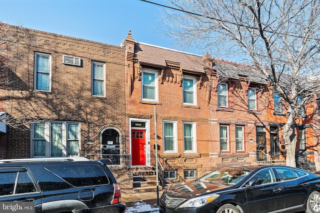 townhome / multi-family property featuring brick siding