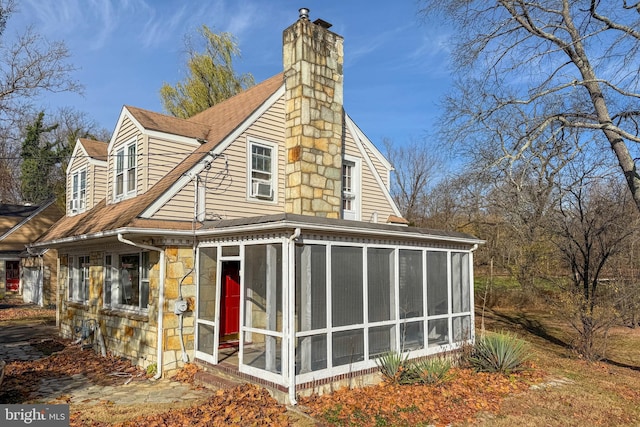 back of house featuring a sunroom