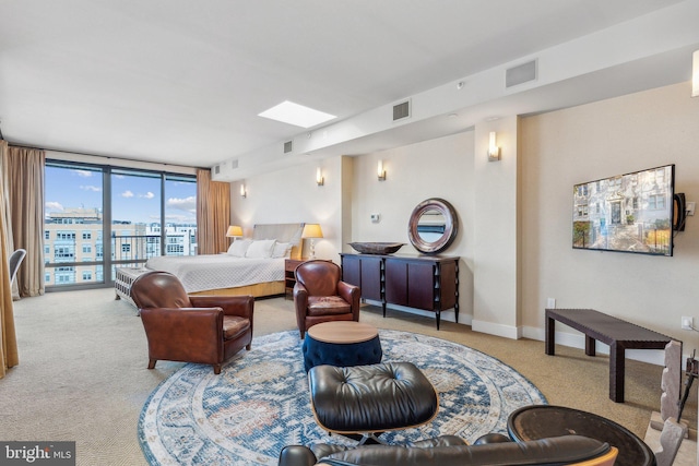 carpeted bedroom with access to outside and a wall of windows