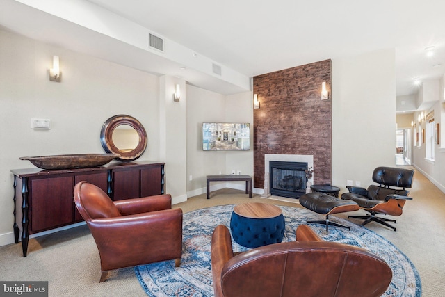 carpeted living room featuring a fireplace