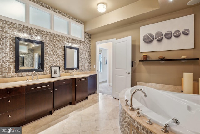 bathroom featuring tile patterned floors, vanity, and tiled tub