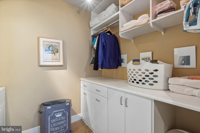 laundry area featuring cabinets