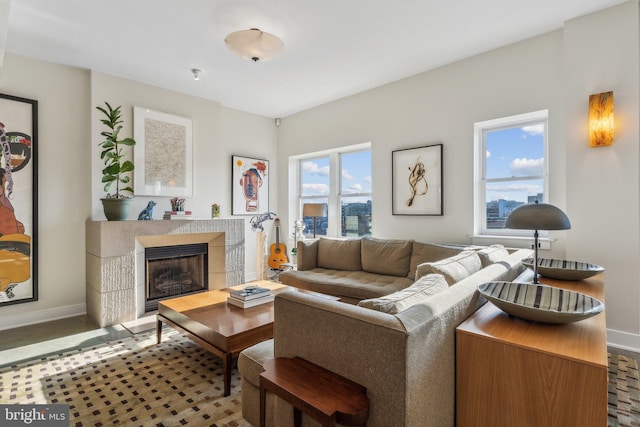 living room with plenty of natural light and a tiled fireplace