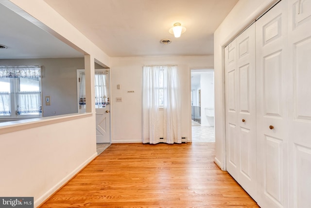 foyer entrance with plenty of natural light and light hardwood / wood-style floors