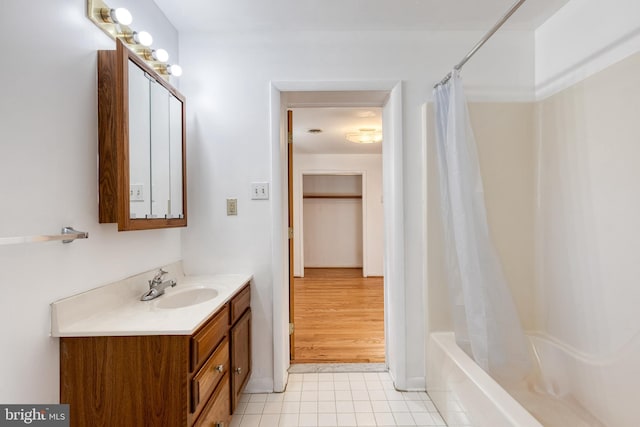 bathroom featuring tile patterned floors, vanity, and shower / tub combo with curtain