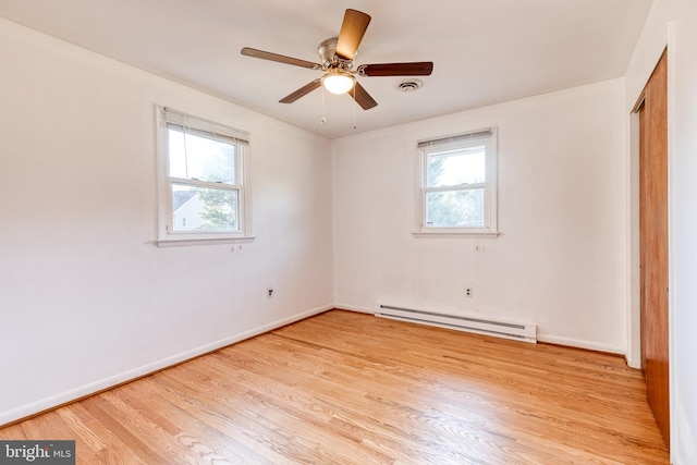 empty room with a baseboard radiator, ceiling fan, and light hardwood / wood-style floors