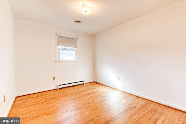 spare room featuring light hardwood / wood-style floors and baseboard heating