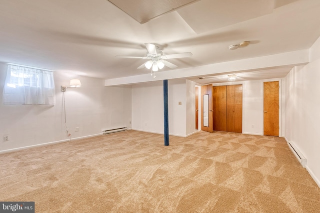 basement with light carpet, a baseboard radiator, and ceiling fan