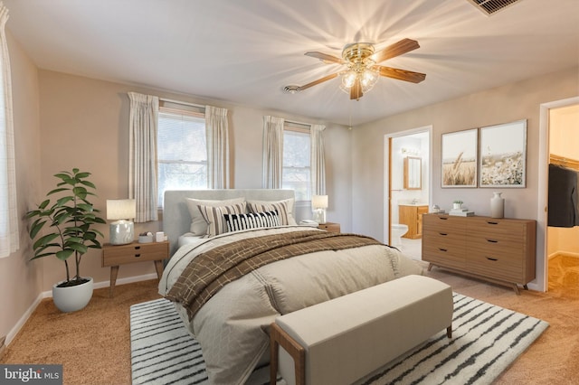 bedroom with connected bathroom, ceiling fan, and light colored carpet