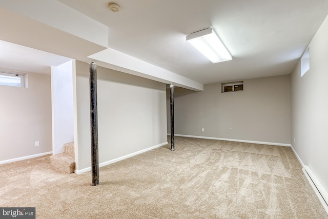 basement with carpet and a baseboard heating unit