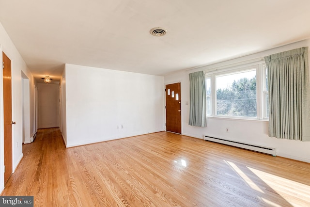 interior space with a baseboard radiator and light hardwood / wood-style floors