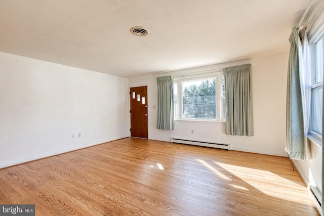 entrance foyer featuring light hardwood / wood-style flooring and a baseboard radiator